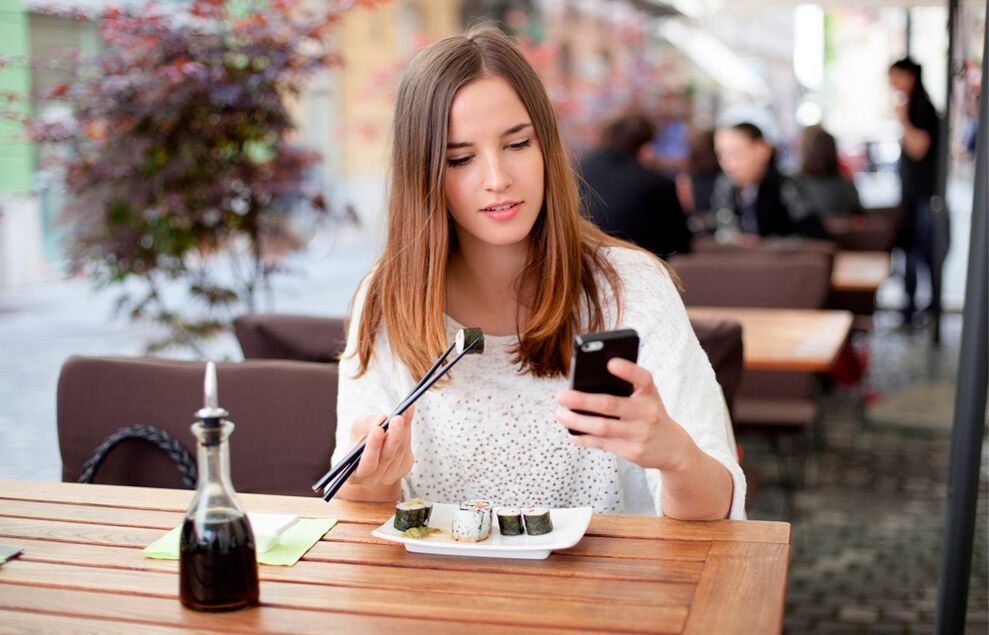 While eating, the attention-grabbing girl eats more than she needs