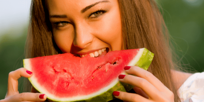 The girl eats watermelon to lose weight